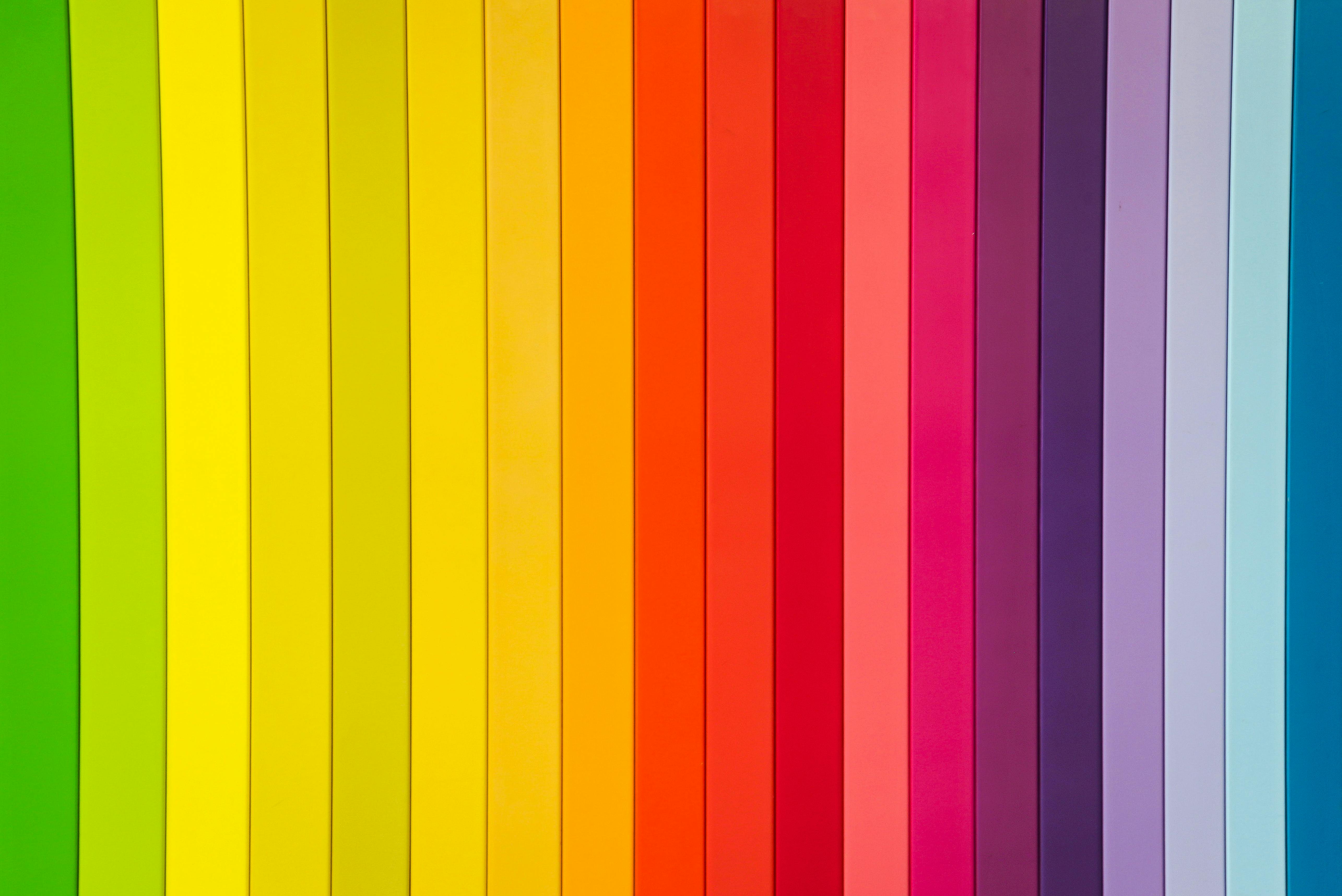 The image shows primary colours arranged side by side, starting from green, blending into yellow, then orange, red, pink, purple and ending in indigo blue